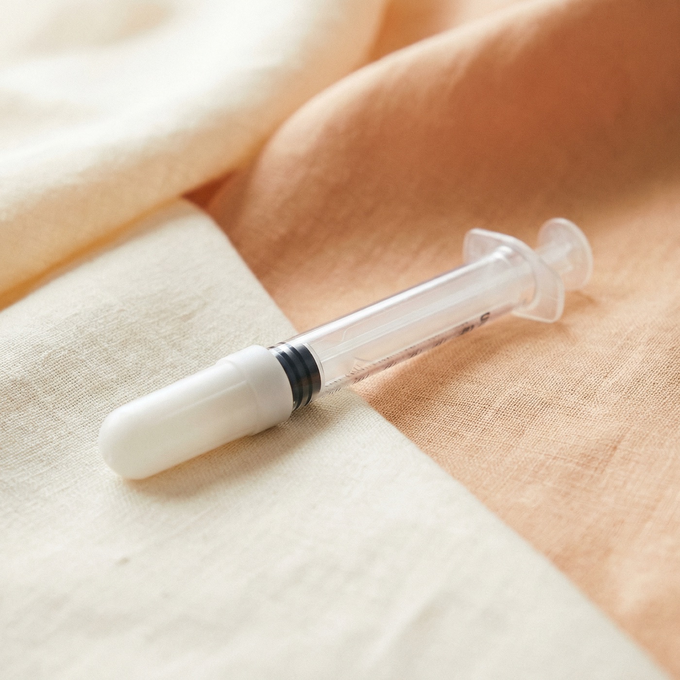 Sterile single-use syringe drawing medication from vial
